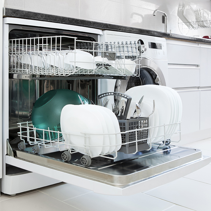 Clean dishes sitting in a dishwasher with the door open and the racks out